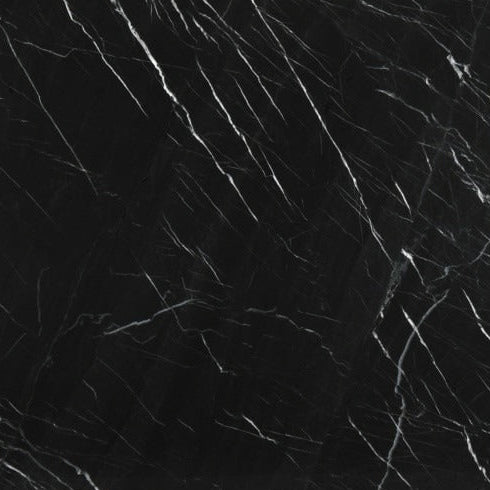 Black marble slab with visible veins on a stand against a dark background